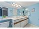 Well-lit bathroom boasting double sinks, vanity, and a soothing ambiance at 19937 E Loyola Pl, Aurora, CO 80013