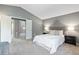 This primary bedroom features a neutral color palette, plush carpet and en-suite bathroom at 19937 E Loyola Pl, Aurora, CO 80013