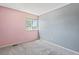 Bedroom featuring two-toned walls, carpet, and a window for natural light at 19937 E Loyola Pl, Aurora, CO 80013