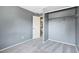 Cozy bedroom showcasing neutral walls, carpet, and an open closet at 19937 E Loyola Pl, Aurora, CO 80013