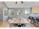 Dining area with two windows, wood floors, seating for six and light gray walls at 19937 E Loyola Pl, Aurora, CO 80013