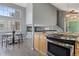 Gourmet kitchen with granite counters, wood floors, stainless appliances and breakfast nook at 19937 E Loyola Pl, Aurora, CO 80013