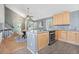 Kitchen with gray walls, wood floors, stainless appliances, granite counters and breakfast nook at 19937 E Loyola Pl, Aurora, CO 80013