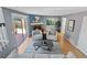 Bright living room with hardwood floors, fireplace, backyard access, and neutral paint at 19937 E Loyola Pl, Aurora, CO 80013