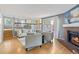Open-concept living area featuring a cozy fireplace, hardwood floors, and seamless flow to the dining area at 19937 E Loyola Pl, Aurora, CO 80013