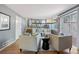 Sunlit living room boasts an open floor plan with stairs to an upper level and sliding door access to the patio at 19937 E Loyola Pl, Aurora, CO 80013
