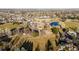 Aerial shot of neighborhood park including playground, pond, and green space at 11899 Elizabeth Cir, Thornton, CO 80233