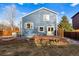 Spacious backyard featuring a deck, garden beds, and mature trees for privacy and shade at 11899 Elizabeth Cir, Thornton, CO 80233