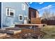 Spacious backyard with a deck, lush lawn, and garden beds, perfect for outdoor living at 11899 Elizabeth Cir, Thornton, CO 80233