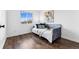 Comfortable bedroom features modern decor, hardwood floors, and a window providing ample natural light at 11899 Elizabeth Cir, Thornton, CO 80233