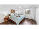 Cozy bedroom featuring a comfortable bed, natural light from a large window, and modern decor at 11899 Elizabeth Cir, Thornton, CO 80233