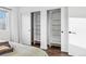 Bedroom closet featuring ample shelving and sliding doors offering convenient storage solutions at 11899 Elizabeth Cir, Thornton, CO 80233