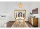Bright dining area with hardwood floors, a bay window, and a decorative light fixture at 11899 Elizabeth Cir, Thornton, CO 80233