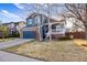 Charming two-story home with a well-maintained lawn, brick accents, and an attached two-car garage at 11899 Elizabeth Cir, Thornton, CO 80233