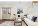 Comfortable living room boasts hardwood floors, an area rug, modern decor, and great natural light at 11899 Elizabeth Cir, Thornton, CO 80233