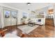 Inviting living room with hardwood floors, a comfortable white sofa, and large windows at 11899 Elizabeth Cir, Thornton, CO 80233