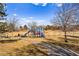 Colorful playground featuring slides and swings, nestled in a grassy park with walking path and blue skies at 11899 Elizabeth Cir, Thornton, CO 80233