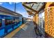 Modern light rail station with a covered platform, bench seating and blue train at 11899 Elizabeth Cir, Thornton, CO 80233