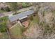 Aerial view of a brick home featuring an outdoor patio and mature trees on a well-maintained lot at 8750 W 8Th Ave, Lakewood, CO 80215