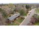 An aerial view of a brick home near a street with mature trees providing shade and privacy at 8750 W 8Th Ave, Lakewood, CO 80215