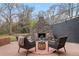 Backyard patio with comfortable seating around a stone fireplace, perfect for outdoor relaxation at 8750 W 8Th Ave, Lakewood, CO 80215