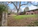 Large backyard featuring mature trees, a brick patio, and a multi-level home with great outdoor living spaces at 8750 W 8Th Ave, Lakewood, CO 80215