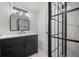 Updated bathroom featuring a black vanity and glass shower at 8750 W 8Th Ave, Lakewood, CO 80215
