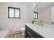 Modern bathroom featuring a stylish vanity and intricate floor tiles at 8750 W 8Th Ave, Lakewood, CO 80215