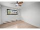 Minimalist bedroom with hardwood floors, single window and neutral walls at 8750 W 8Th Ave, Lakewood, CO 80215