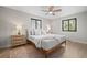 Cozy bedroom with hardwood floors, two large windows, and ceiling fan at 8750 W 8Th Ave, Lakewood, CO 80215