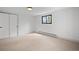 Bedroom with large window, light carpet, and view to the outside at 8750 W 8Th Ave, Lakewood, CO 80215