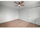 Bright bedroom featuring light hardwood floors and a ceiling fan at 8750 W 8Th Ave, Lakewood, CO 80215