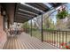 Spacious deck with metal awning, black metal railing, wood flooring, and beautiful backyard views at 8750 W 8Th Ave, Lakewood, CO 80215