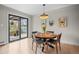 Cozy dining room with sliding glass door, hardwood floors, decorative accents, and a view of the backyard at 8750 W 8Th Ave, Lakewood, CO 80215