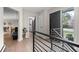 Inviting entryway featuring a stylish door, modern railing, and view to the kitchen and dining area at 8750 W 8Th Ave, Lakewood, CO 80215