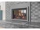 Close-up of a gas fireplace with a contemporary brick surround at 8750 W 8Th Ave, Lakewood, CO 80215