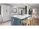 Modern kitchen featuring an island with seating, quartz countertops and stainless steel appliances at 8750 W 8Th Ave, Lakewood, CO 80215