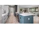 Kitchen island with quartz countertop and oven, adjacent to living room, great for entertaining at 8750 W 8Th Ave, Lakewood, CO 80215