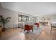 Spacious living room with modern decor, hardwood floors, large windows, and an adjoining dining area at 8750 W 8Th Ave, Lakewood, CO 80215