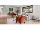 Bright living room with hardwood floors, stylish seating, large windows, and a cozy atmosphere at 8750 W 8Th Ave, Lakewood, CO 80215