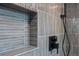 Elegant shower featuring vertical tile, a shower niche, and modern matte black fixtures at 8750 W 8Th Ave, Lakewood, CO 80215