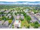 Beautiful aerial view of a neighborhood showcasing tree-lined streets, community pool, and green spaces at 1250 S Monaco Pkwy # 67, Denver, CO 80224