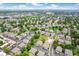 Expansive aerial view of a community with lush greenery, manicured lawns, and a refreshing pool at 1250 S Monaco Pkwy # 67, Denver, CO 80224