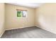 Cozy bedroom featuring neutral walls, plush gray carpeting, and a sunlit window at 1250 S Monaco Pkwy # 67, Denver, CO 80224