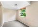 Simple bedroom featuring neutral walls, carpet flooring, and a bright window at 1250 S Monaco Pkwy # 67, Denver, CO 80224