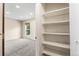 Bright bedroom view with neutral walls, plush carpeting, and closet with built in shelving at 1250 S Monaco Pkwy # 67, Denver, CO 80224