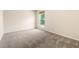 A bedroom featuring carpet, walls, window, and view at 1250 S Monaco Pkwy # 67, Denver, CO 80224