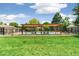 Relaxing community pool area with pergola shading lounge chairs and a secure fenced perimeter at 1250 S Monaco Pkwy # 67, Denver, CO 80224