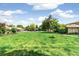 Beautiful community pool surrounded by lush green lawns and mature trees on a sunny day at 1250 S Monaco Pkwy # 67, Denver, CO 80224