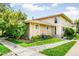 Charming two-story townhome with stone facade and well-maintained front lawn and landscaping at 1250 S Monaco Pkwy # 67, Denver, CO 80224